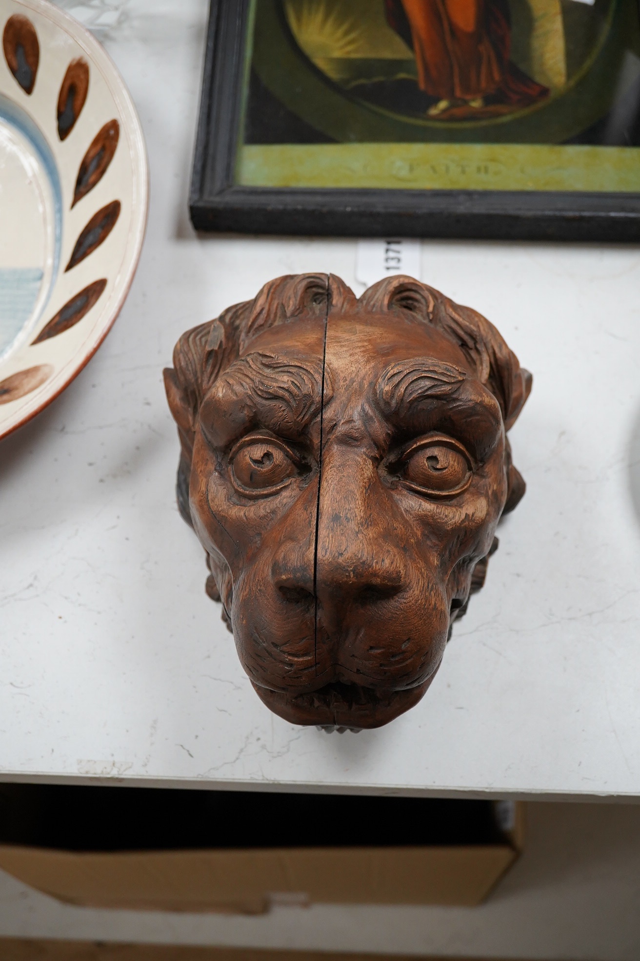 An 19th century carved 'Lion's head' corbel, 21cm high. Condition - poor